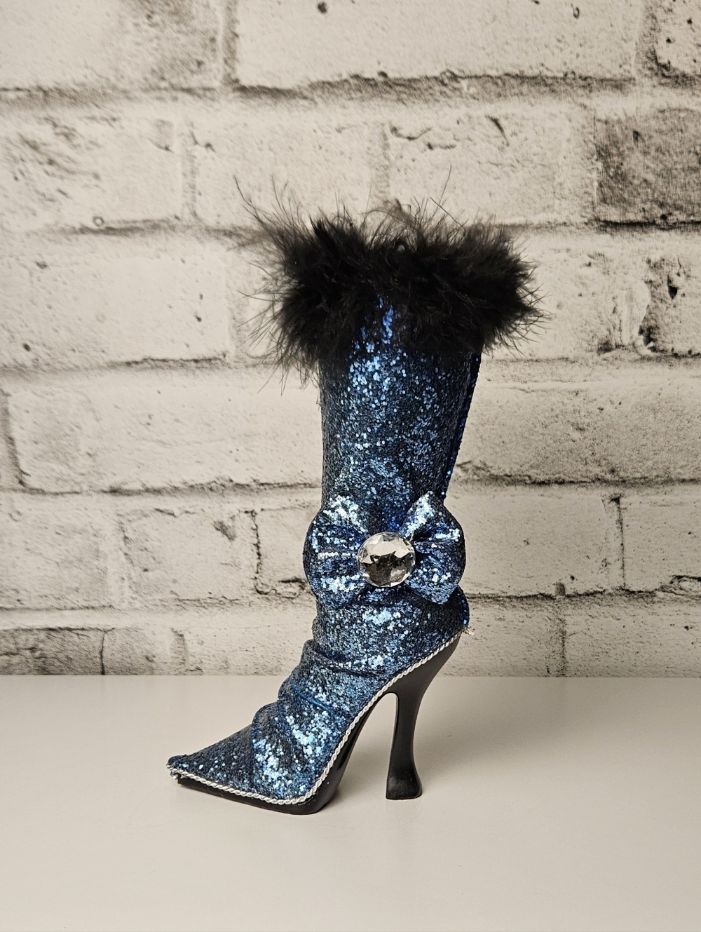 Decorative high heel boot that doubles as a coin bank or small vase”
